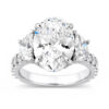 Oval-cut diamond three-stone engagement ring with sparkling diamond accents