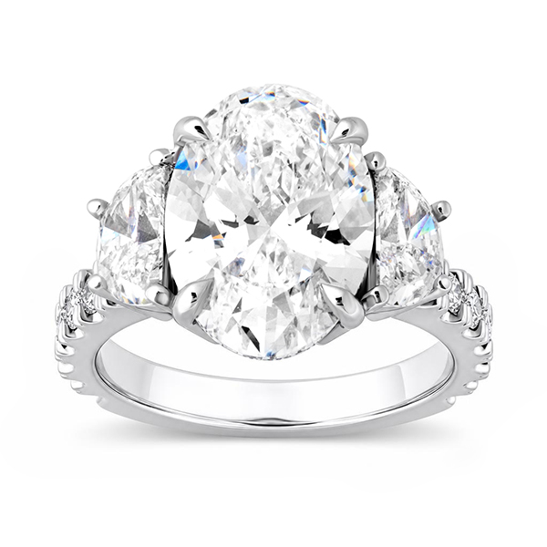 Oval-cut diamond three-stone engagement ring with sparkling diamond accents